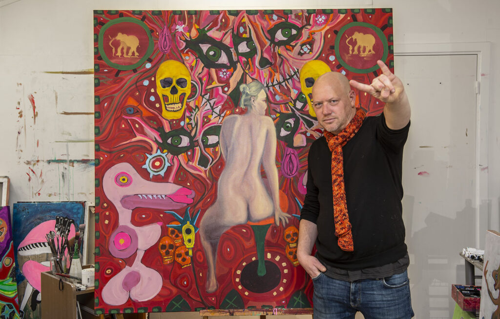 Fishbain posing in front of his painting Red tex mex